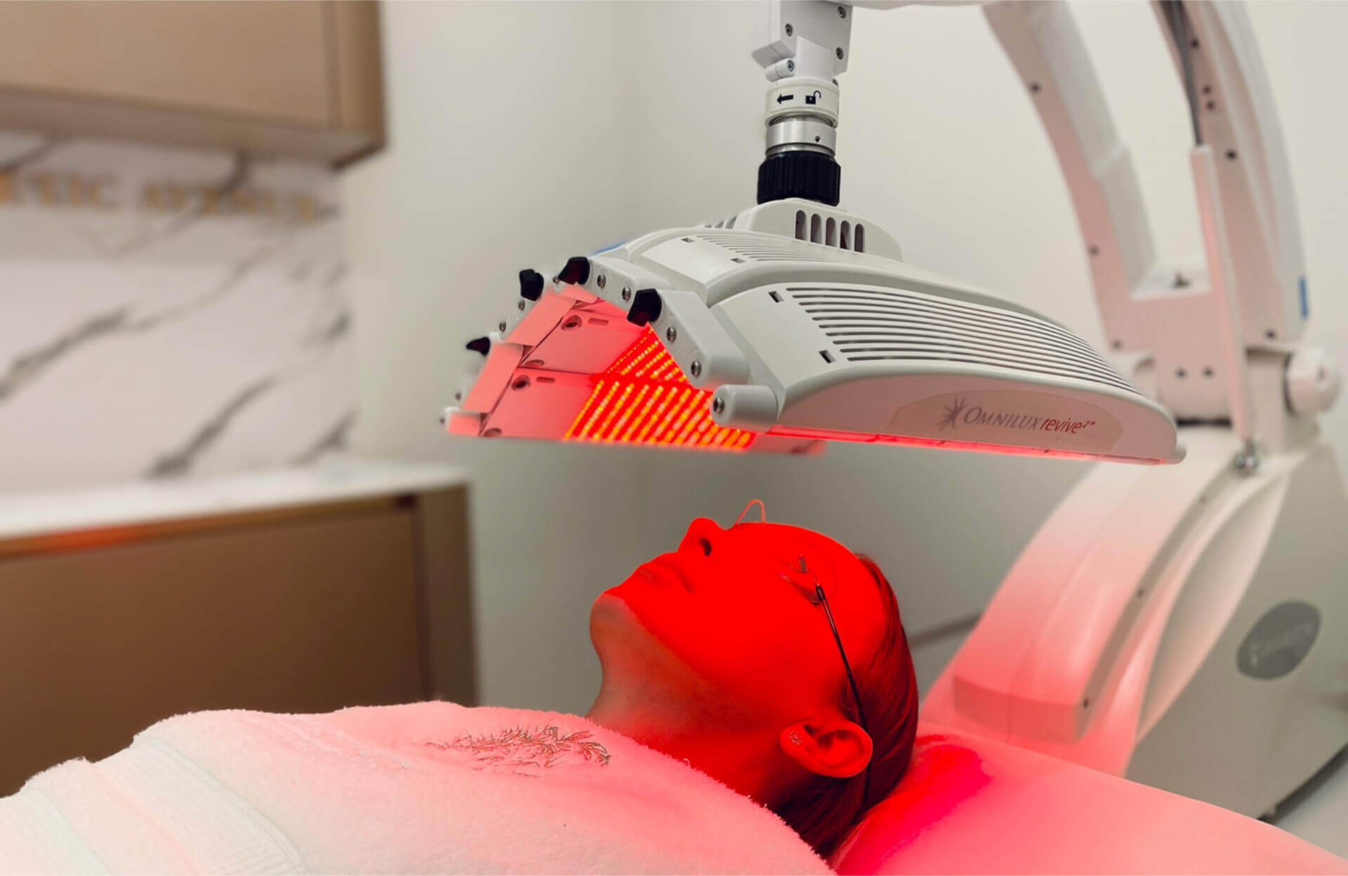Woman relaxing during an anti-aging light therapy session