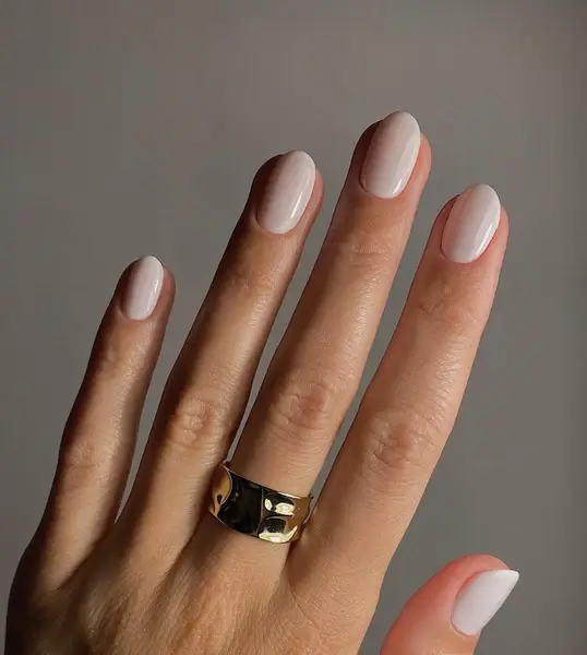 Manicured hands with a neutral polish